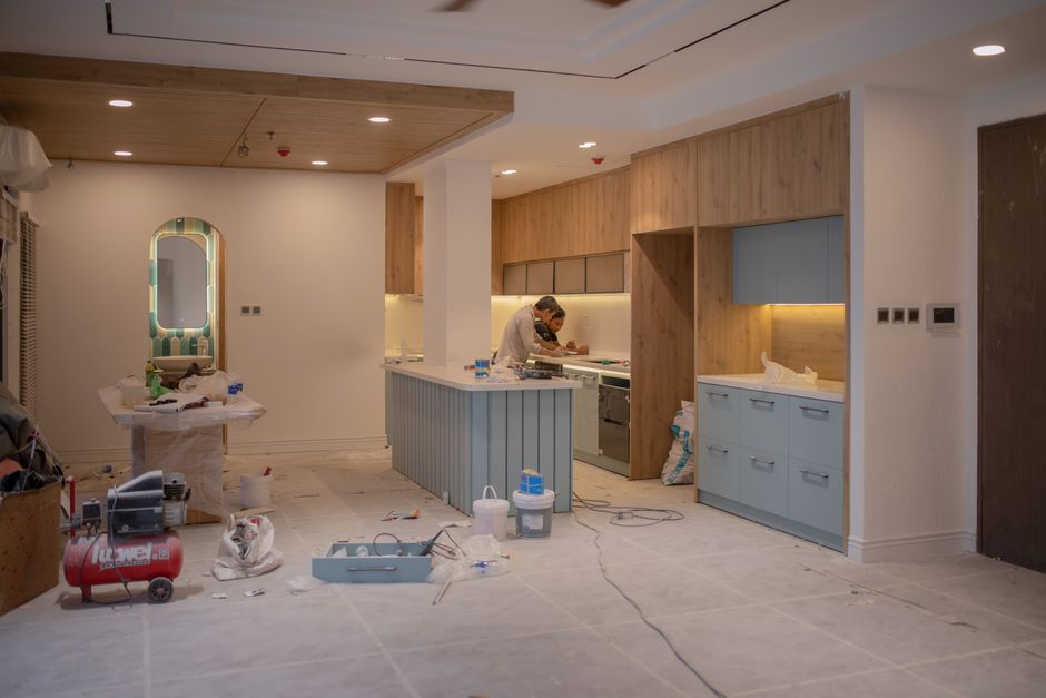 Master carpenter installing custom kitchen cabinets